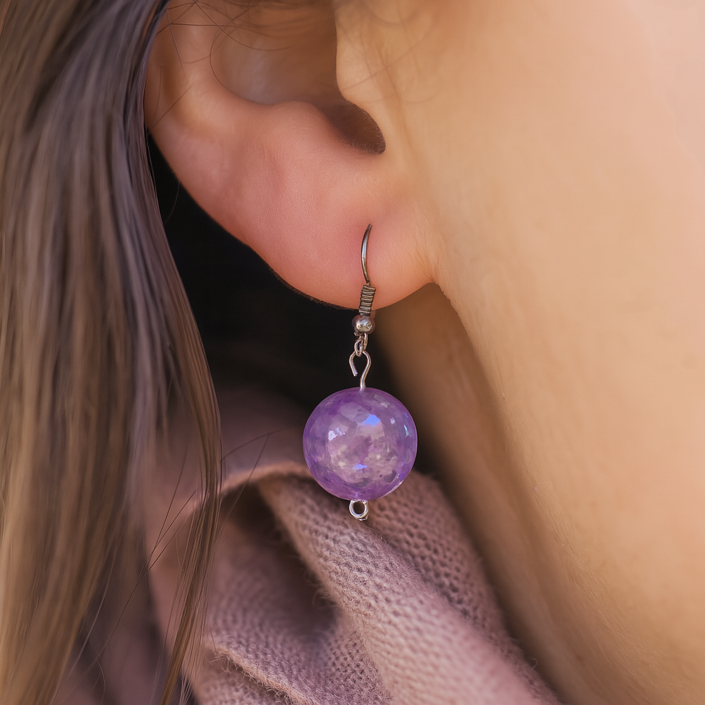 Bohemian-style handmade earrings featuring shimmering purple beads and metallic findings