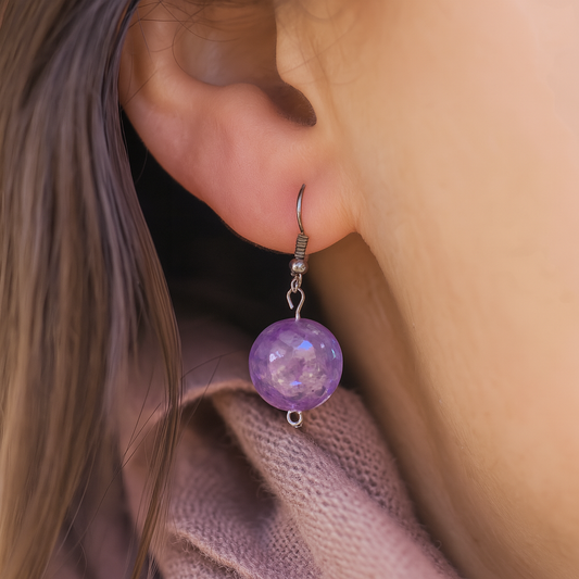 Bohemian-style handmade earrings featuring shimmering purple beads and metallic findings