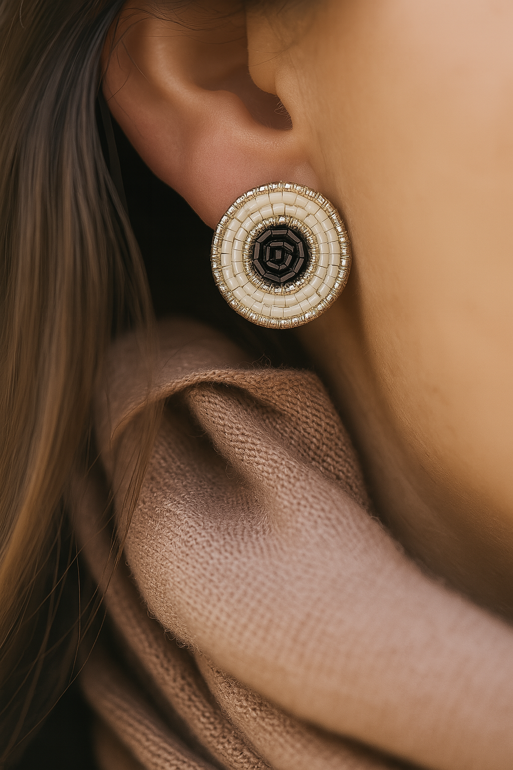 Bohemian handcrafted earrings featuring concentric beadwork in black, white, and metallic accents