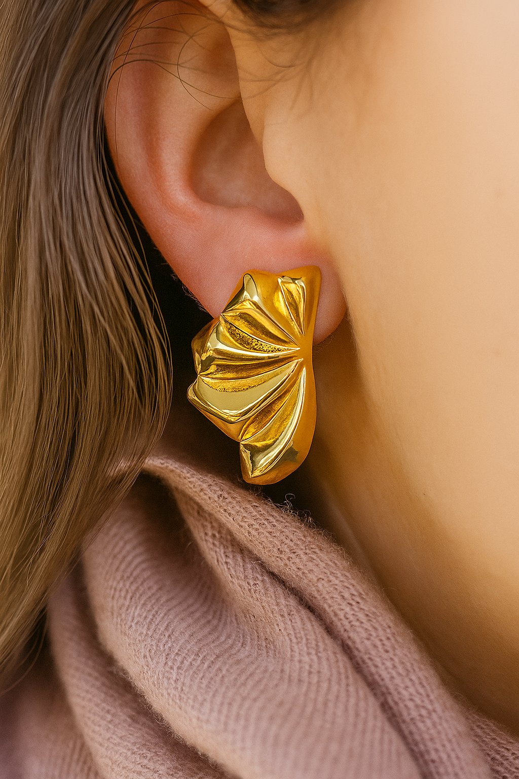 Bold abstract gold hoops with high-shine finish and unique wave-inspired texture