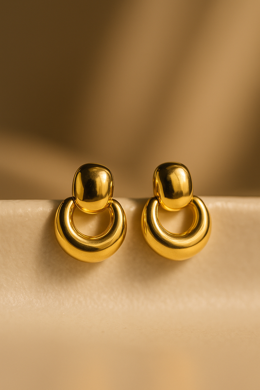 Bold gold dome-shaped drop earrings with circular loop design, polished finish for a luxe statement look