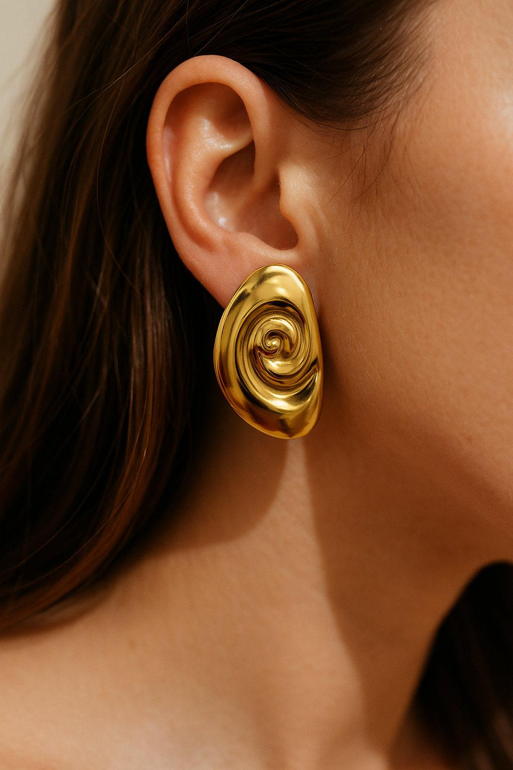High-shine gold oval earring with abstract twisted design, bold sculptural jewelry for festive and party wear