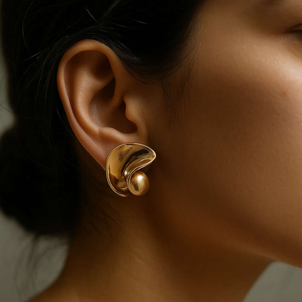 Contemporary sculpted gold hoops with high-shine anti-rust finish and fluid curves