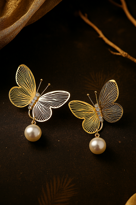 Delicate gold tone butterfly earrings with sparkling rhinestones and imitation pearls, elegant fashion accessories