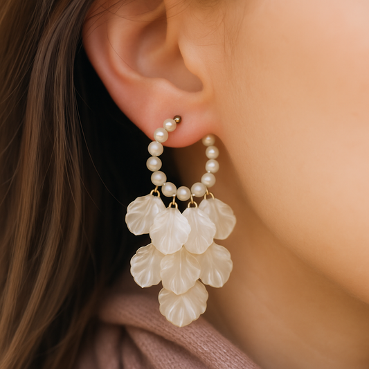 Gold-toned hoop earrings adorned with pearls and cascading shell petals – perfect for festive and vacation looks.