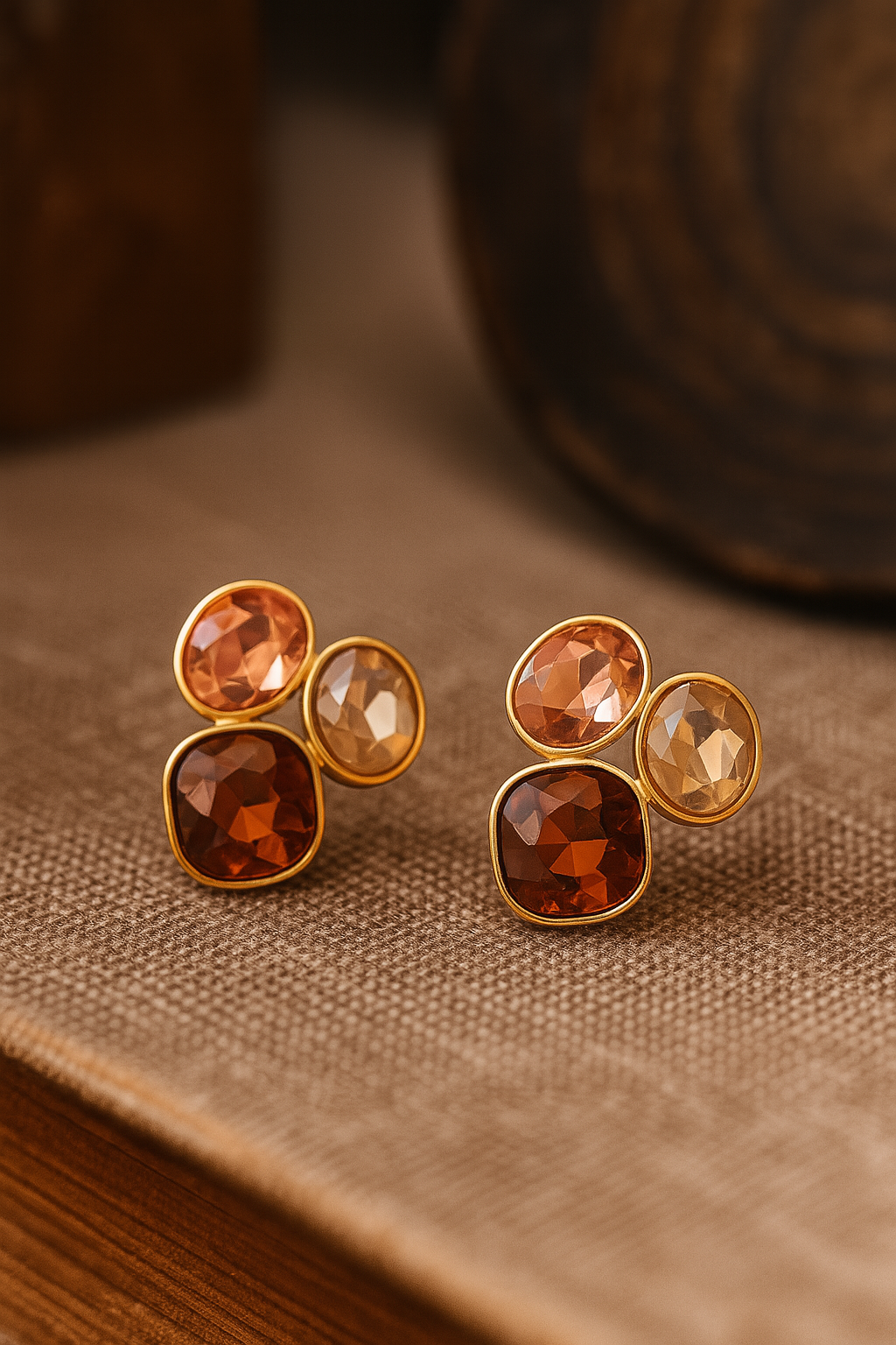 Elegant multi-gemstone stud earrings with square and round crystals in orange, pink, and white tones