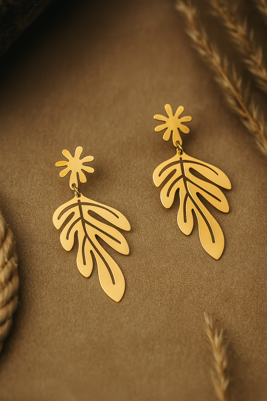 Gold leaf-shaped dangle earrings with floral stud, botanical design in matte finish for boho and festive styling