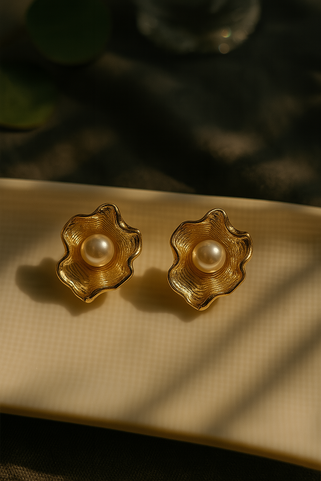 Gold wavy anti-tarnish stud earrings with pearl center – elegant floral design for festive and bridal wear.