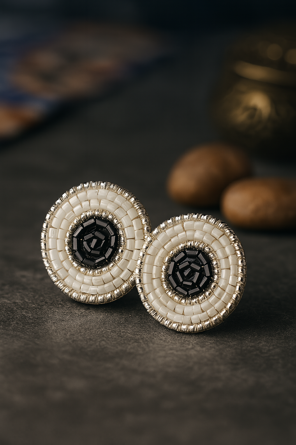 Handmade circular beaded earrings with black center and white seed bead detailing