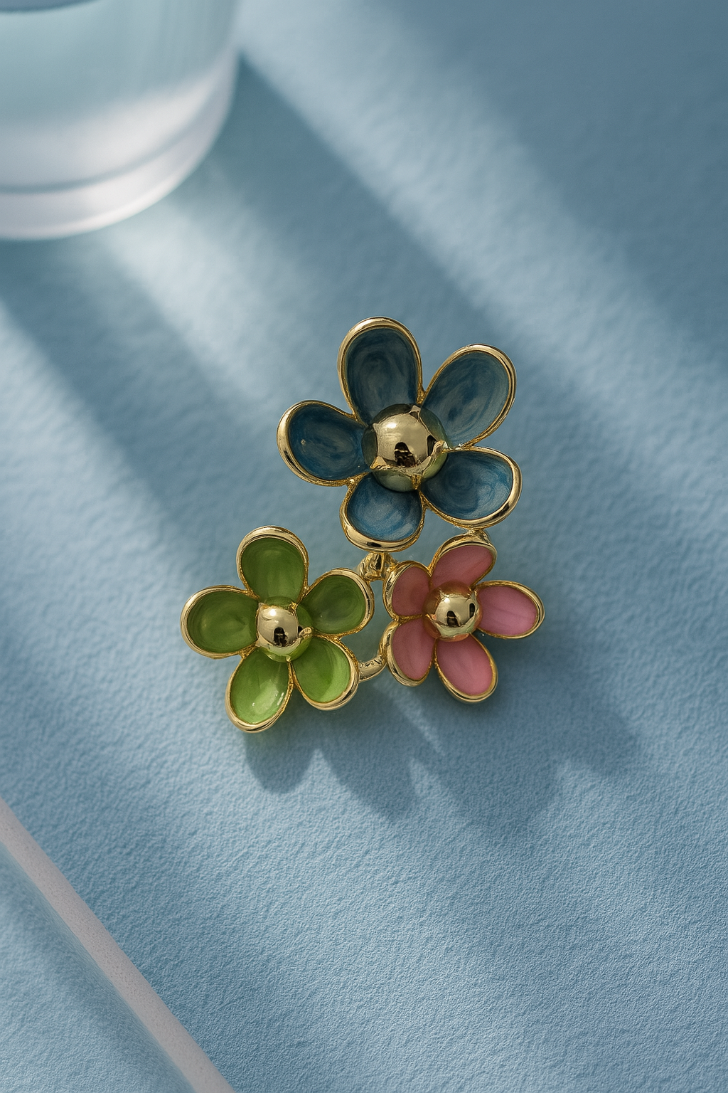 Stylish three-flower stud earrings with blue, pink, and green enamel, gold-tone accents