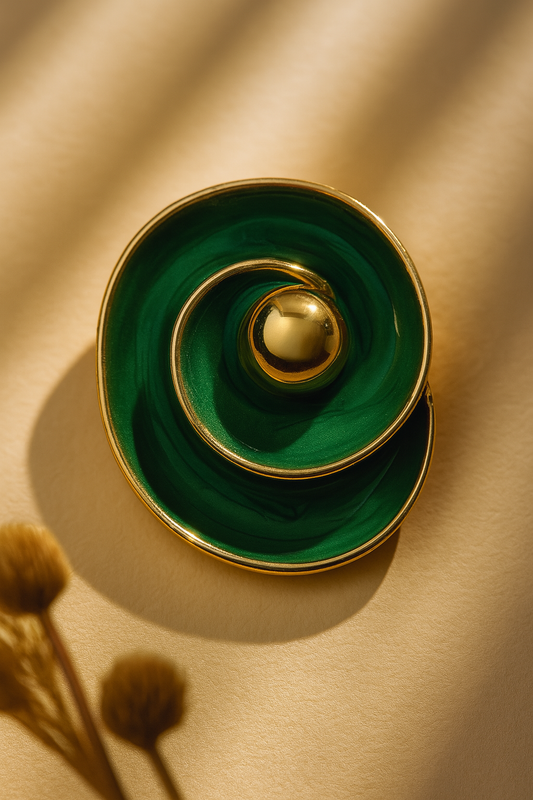 Modern gold-tone stud earrings with deep green swirling design