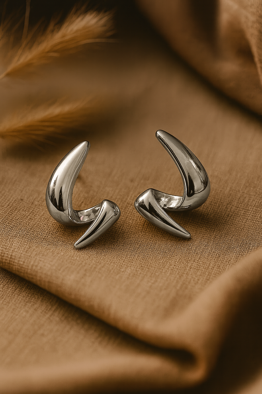 Polished silver sculptural earrings with modern claw-inspired abstract design