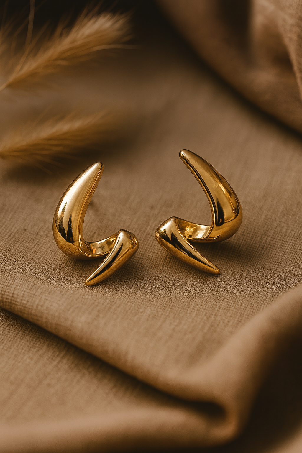 Sculptural gold-plated statement earrings with abstract curved design for women