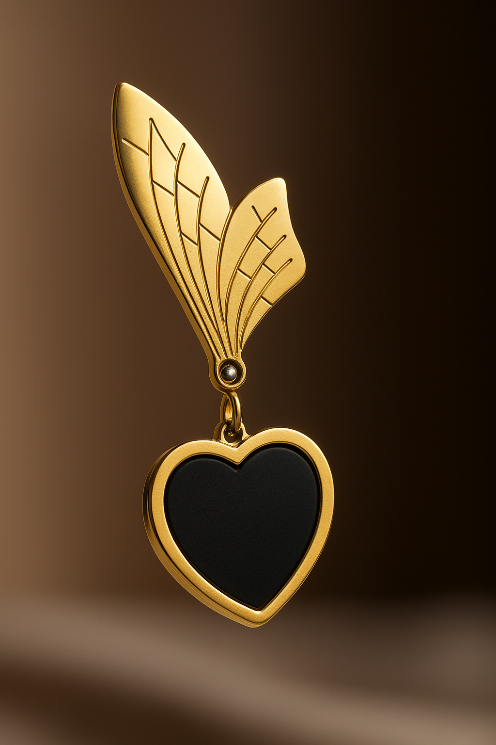 Statement heart-shaped black and gold anti-tarnish earrings with artistic wing detailing.