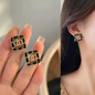 Gold Tone Black Enamel Logo Crystal Square Studs