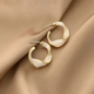 Gold Tone Swirl White Hoop Earrings