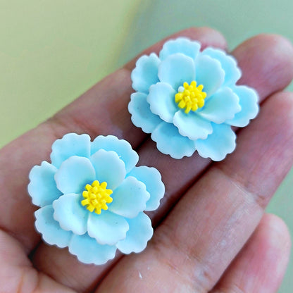 Artisan-crafted polymer clay floral earrings – sky blue petals with bright yellow core, perfect for spring fashion