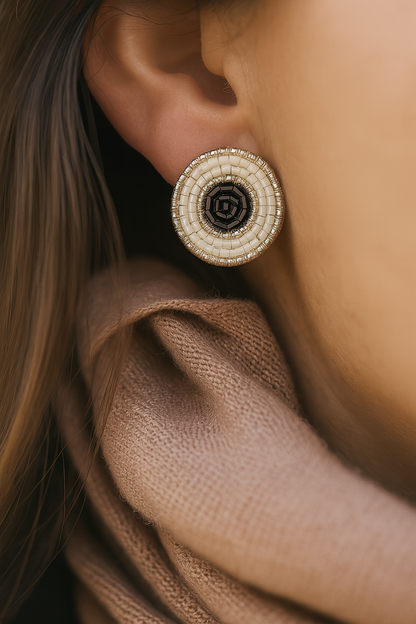 Bohemian handcrafted earrings featuring concentric beadwork in black, white, and metallic accents