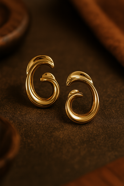 Bold gold abstract swirl earrings with high-shine finish, statement designer jewelry for festive wear and special occasions
