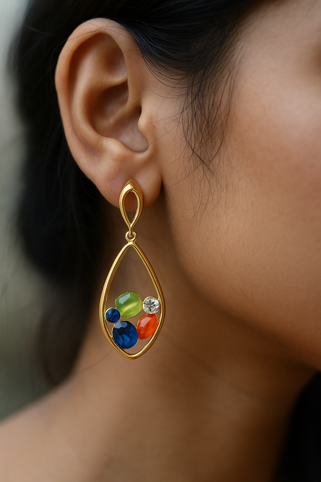 Bold gold drop earrings with open teardrop design and embedded multi-hued gemstones, eye-catching ethnic and party wear jewelry