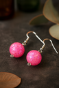 Bright pink handcrafted dangle earrings featuring iridescent mosaic bead design