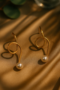 Modern gold swirl earrings with pearl drops, minimalist handcrafted design perfect for statement festive jewelry and elegant gifting