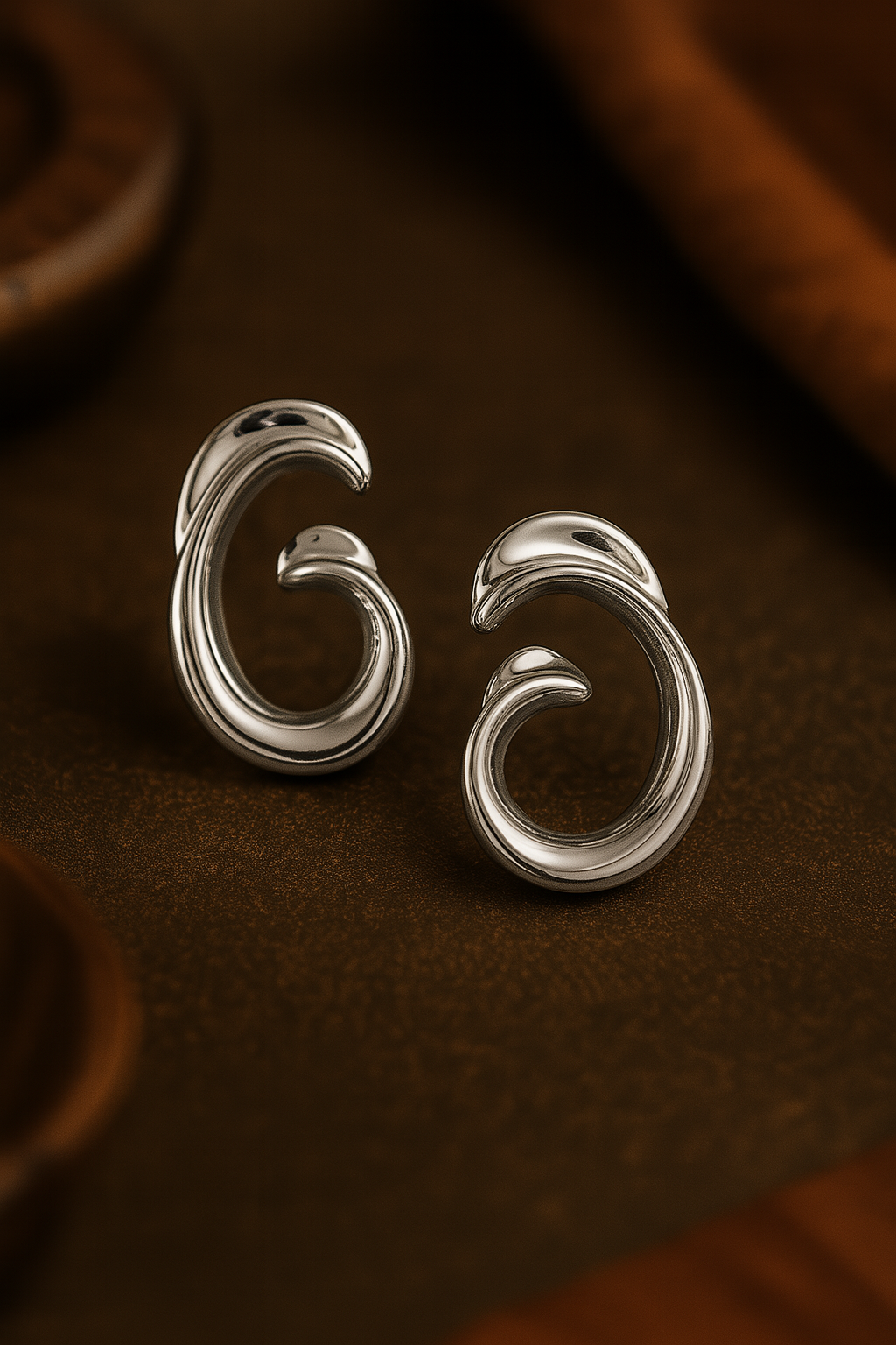 Elegant silver swirl earrings with glossy finish and artistic design, modern jewelry for minimalist and festive looks