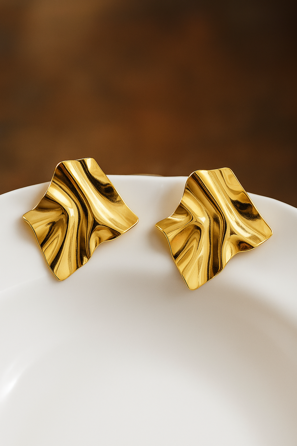 Contemporary crumpled gold square earrings with reflective surface and irregular artistic shape, luxury fashion jewelry
