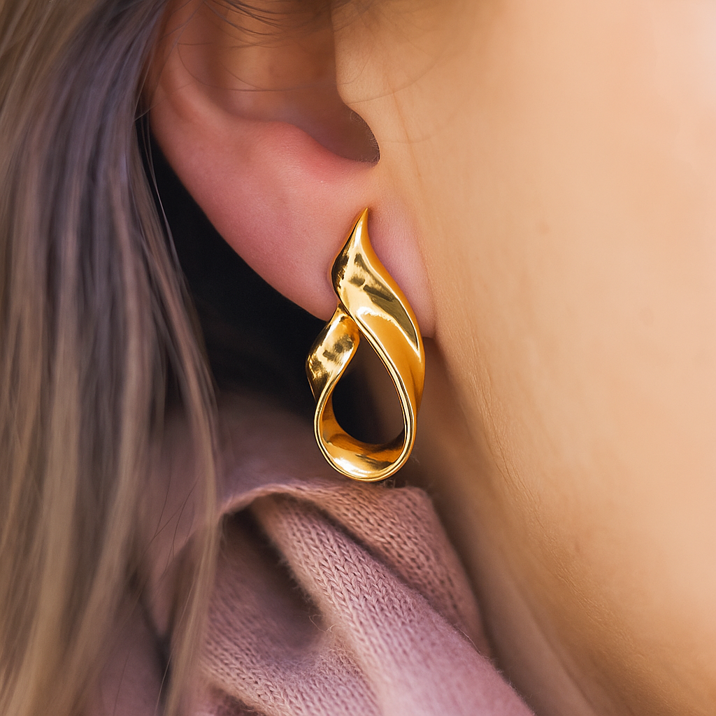 Contemporary statement gold hoops with curved flame-like form and anti-tarnish coating