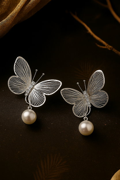 Delicate silver tone butterfly earrings with sparkling rhinestones and imitation pearls, timeless fashion accessories