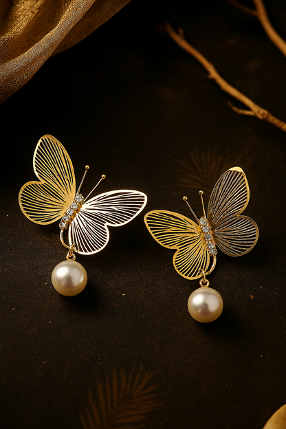 Delicate gold tone butterfly earrings with sparkling rhinestones and imitation pearls, elegant fashion accessories