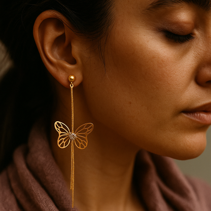 Elegant butterfly drop earrings in anti-tarnish gold finish with cutout wings and sparkling stone