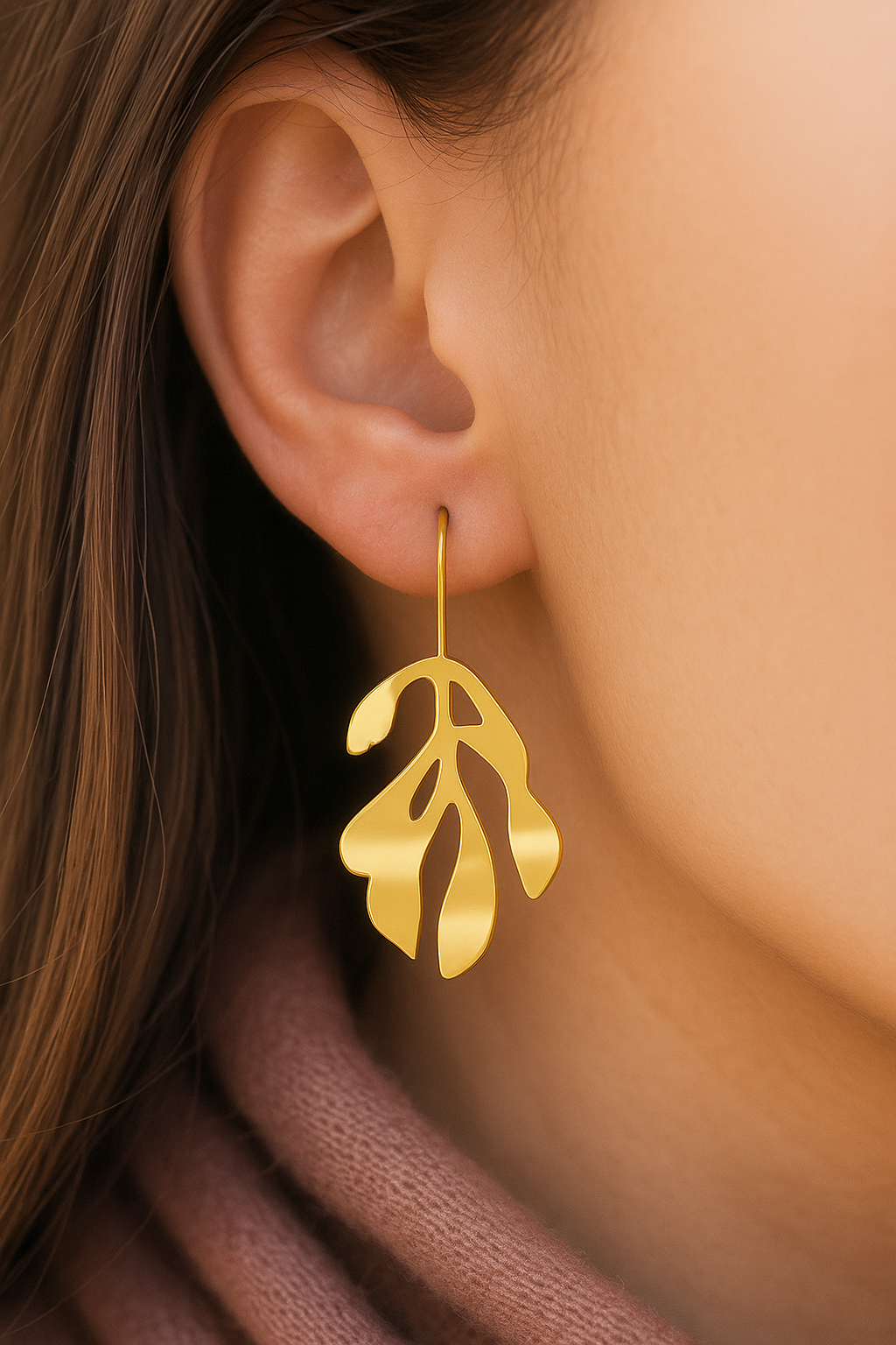 Elegant gold-plated dangler earrings with organic leaf silhouette design