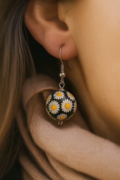 Floral dome earrings featuring white daisies embedded in clear resin with midnight blue base