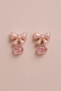 Glossy peach acrylic bow earrings with sparkling peach crystal charm, ideal for summer and gifts