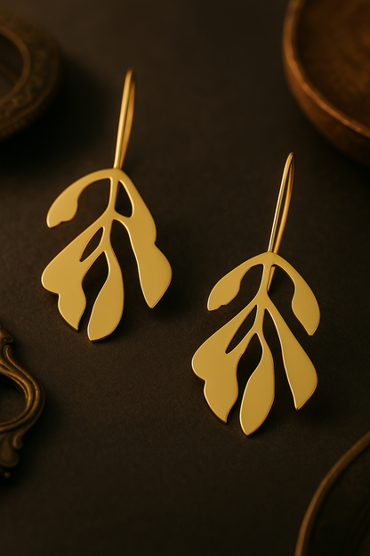 Gold abstract leaf drop earrings in modern artistic design for women
