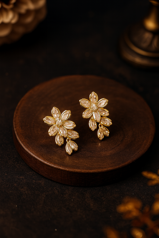 Gold floral anti-tarnish earrings with crystal detailing on dark wood backdrop – perfect for weddings and festive wear