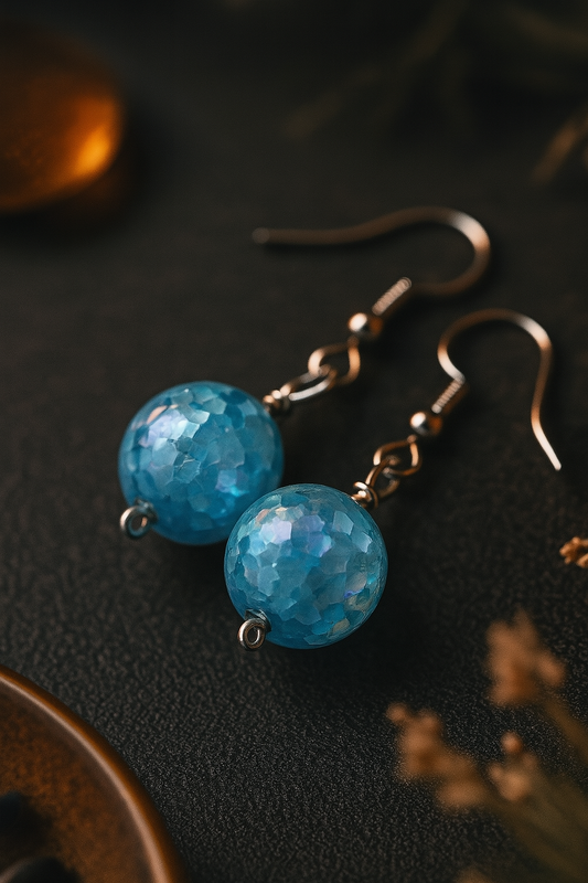 Handmade dangle earrings with faceted blue resin beads and antique bronze hooks