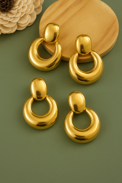 High-shine geometric gold earrings with puffy half-hoop silhouette, ideal for festive and evening wear