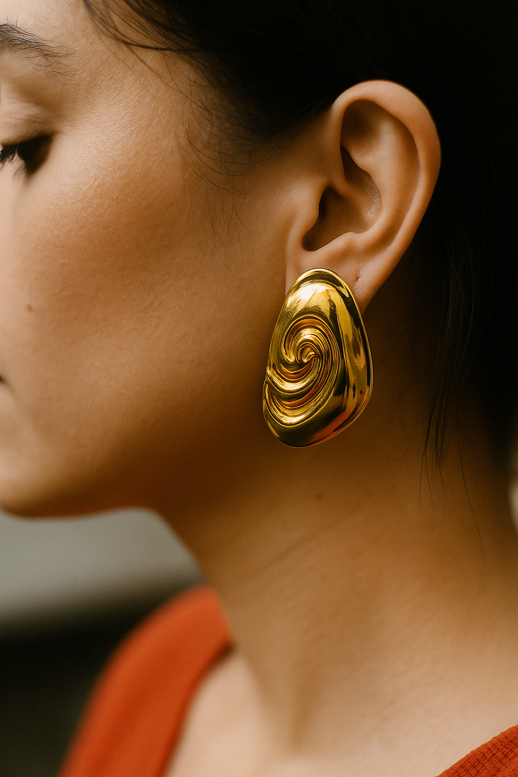 Contemporary  gold earring with embossed spiral texture, perfect for luxe styling and elegant outfits