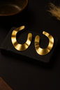 Modern open hoop gold earrings with flat crescent design and matte finish, minimalist statement accessory