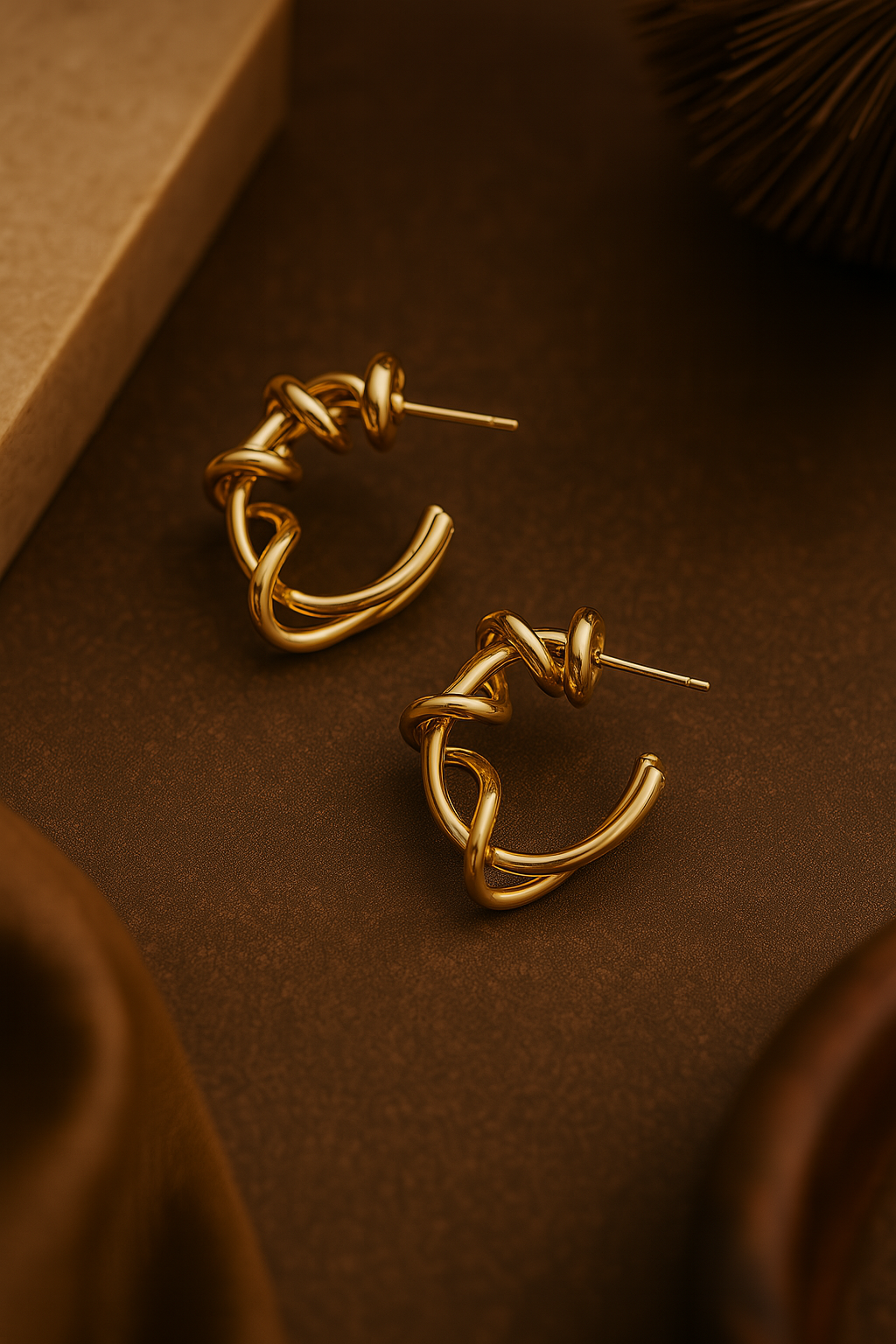 Modern statement gold hoops featuring intertwined sculptural loops and anti-rust finish