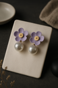 Pastel lavender flower drop earrings with yellow center and white pearl, whimsical floral jewelry for women