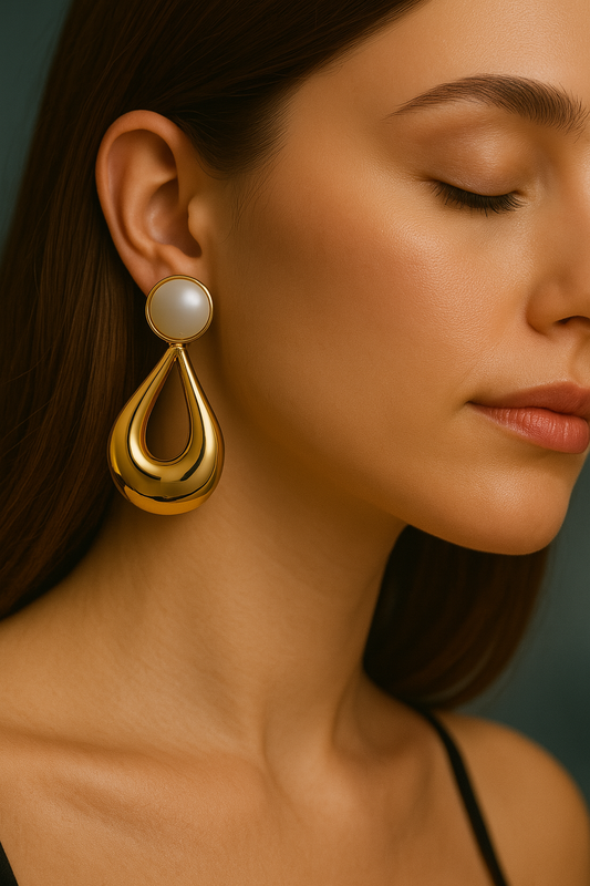 Chunky gold drop earrings with a circular white cabochon, retro inspired fashion accessory