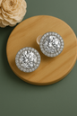 Round silver anti-tarnish stud earrings with large solitaire center and diamond halo – perfect for bridal and party wear