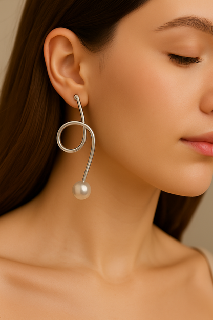 Elegant handcrafted silver wire earrings featuring looped design and pearl drops, versatile jewelry for modern women’s wardrobe