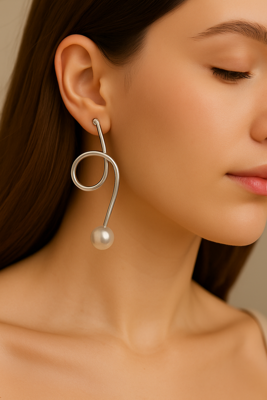 Elegant handcrafted silver wire earrings featuring looped design and pearl drops, versatile jewelry for modern women’s wardrobe