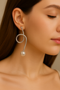Elegant handcrafted silver wire earrings featuring looped design and pearl drops, versatile jewelry for modern women’s wardrobe