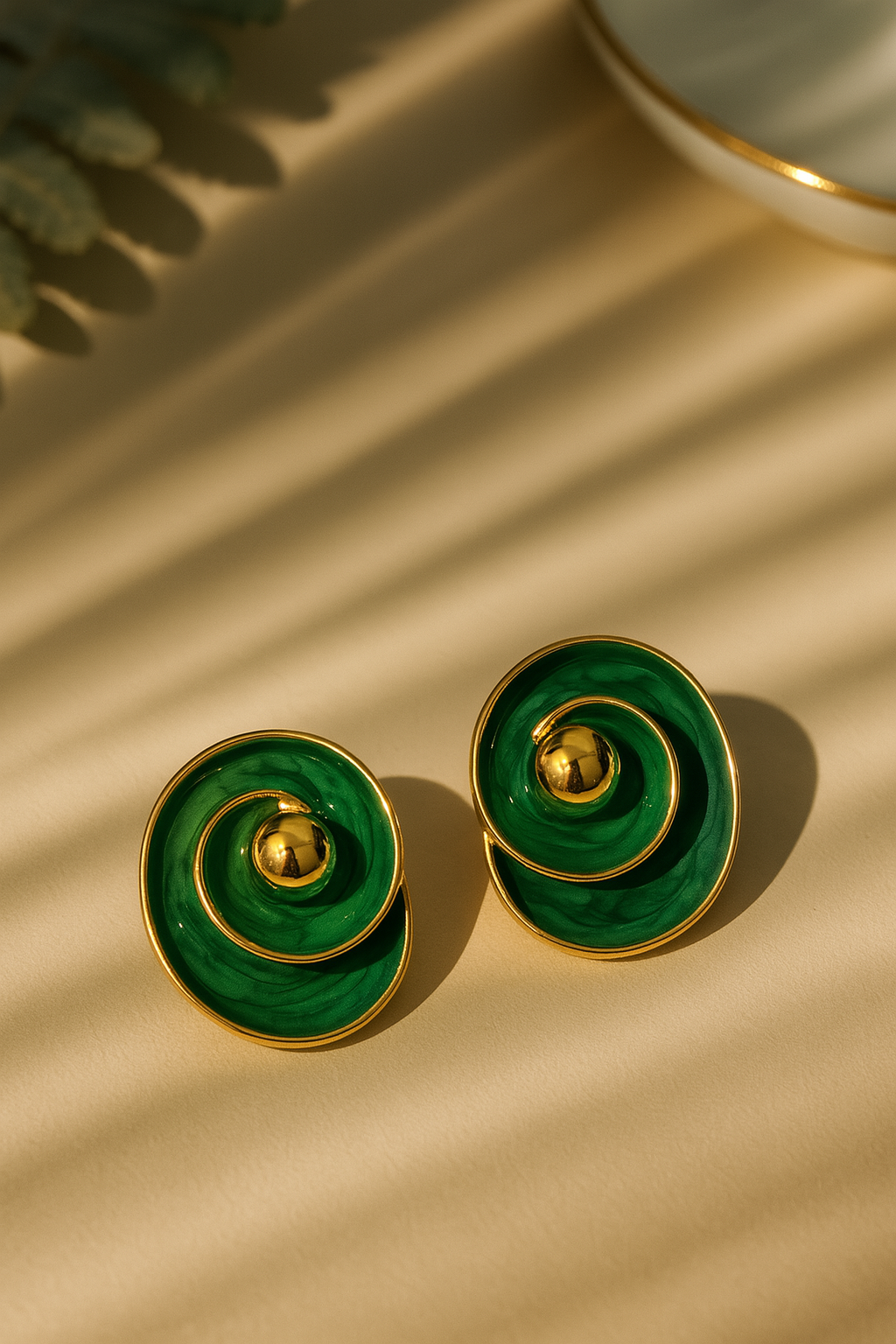 Stylish green enamel concentric spiral earrings with gold ball center