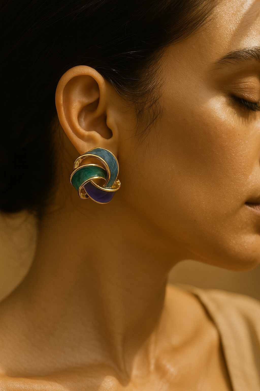 Multicolor twisted knot earrings with glossy enamel and gold detailing – stylish statement studs for modern outfits